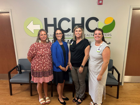 HRSA IEA Regional Administrator Leah Suter (center left) and HCHC's Interim CEO Natalie Bass (center right) are joined by health center staff at an event to celebrate their community partners.