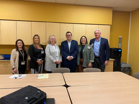 Matthew Salaga, HRSA IEA (center) and Greater Seacoast Community Health CEO Jim Avrett (right) and health center staff.