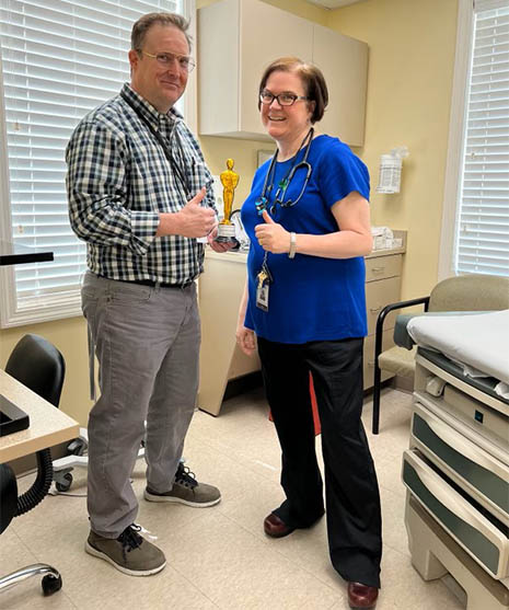Matthew Doolin, RN, Associate Director of Nursing & Clinical Operations, presents Nurse Practitioner Stephanie Delande with the inaugural Duffy handwashing award