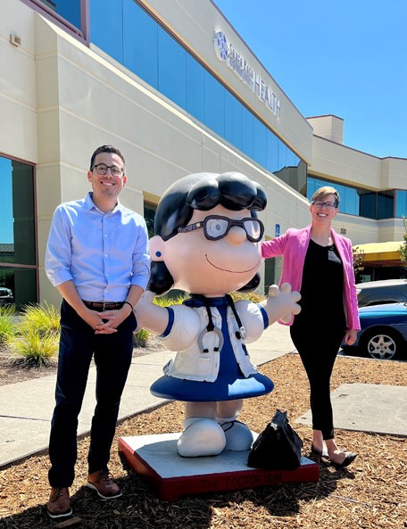 Pictured is Regional Director, Jeff Reynoso and Valerie Gallo, HRSA IEA Region 9 RA, with a Lucy Statue dedicated to Charles Schultz, a prominent donor to the Santa Rosa Health Center.