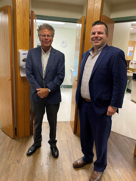 StayWell Health Center CEO Don Thompson and HRSA IEA Region 1 PHA Matthew Salaga in front of a dental health suite at StayWell Health Center in Waterbury, CT.