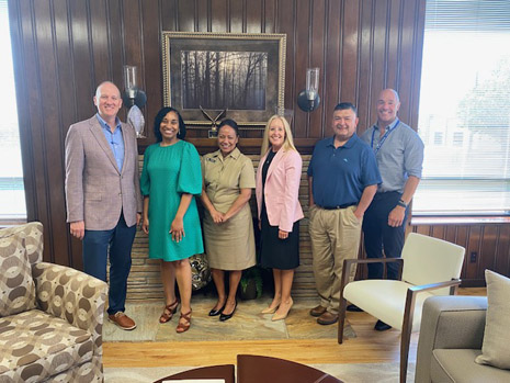 Left to right: Judd Semingson, Chief Executive Officer; T'Ronda Flagg, HRSA IEA Deputy Regional Administrator; LCDR Amy Eden, HRSA IEA; Lisa Stafford, Research Director; John Smith, Compliance Director; Fred Bedore, Chief Operating Officer