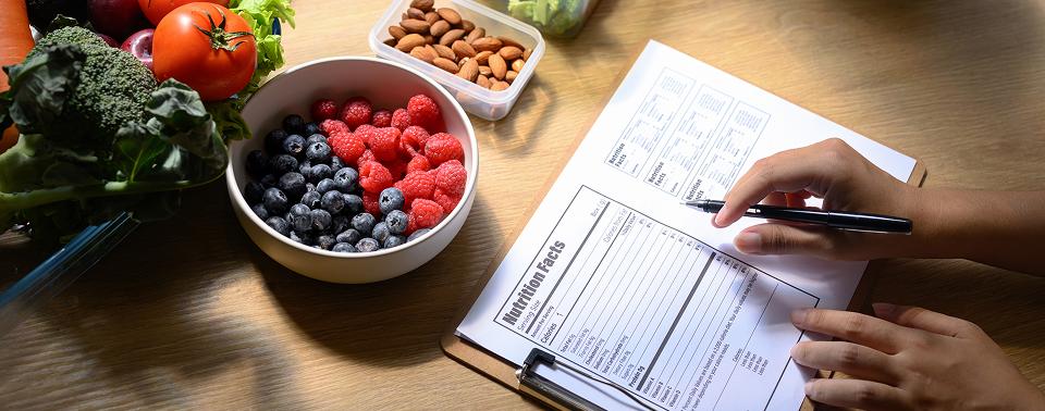 bowl of fruit next to a journal