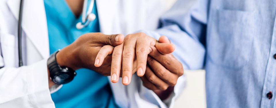 doctor holding patient hands