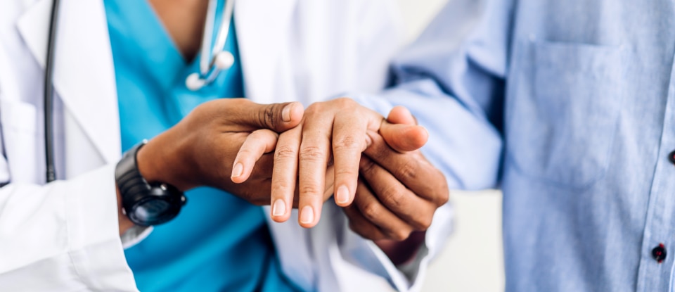 doctor holding patient hands